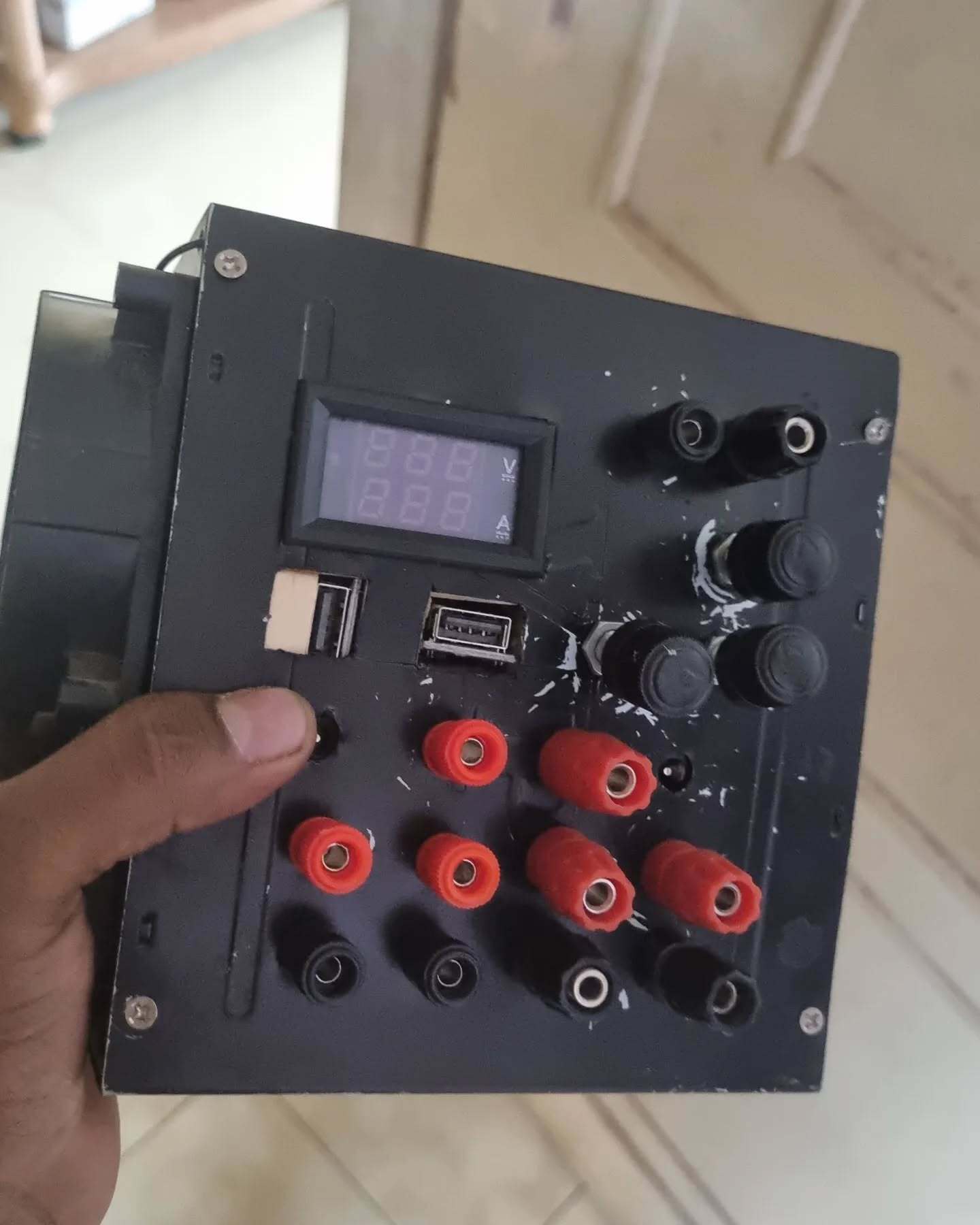Completed DIY benchtop power supply with digital display, USB ports, adjustment knobs, and banana jack outputs